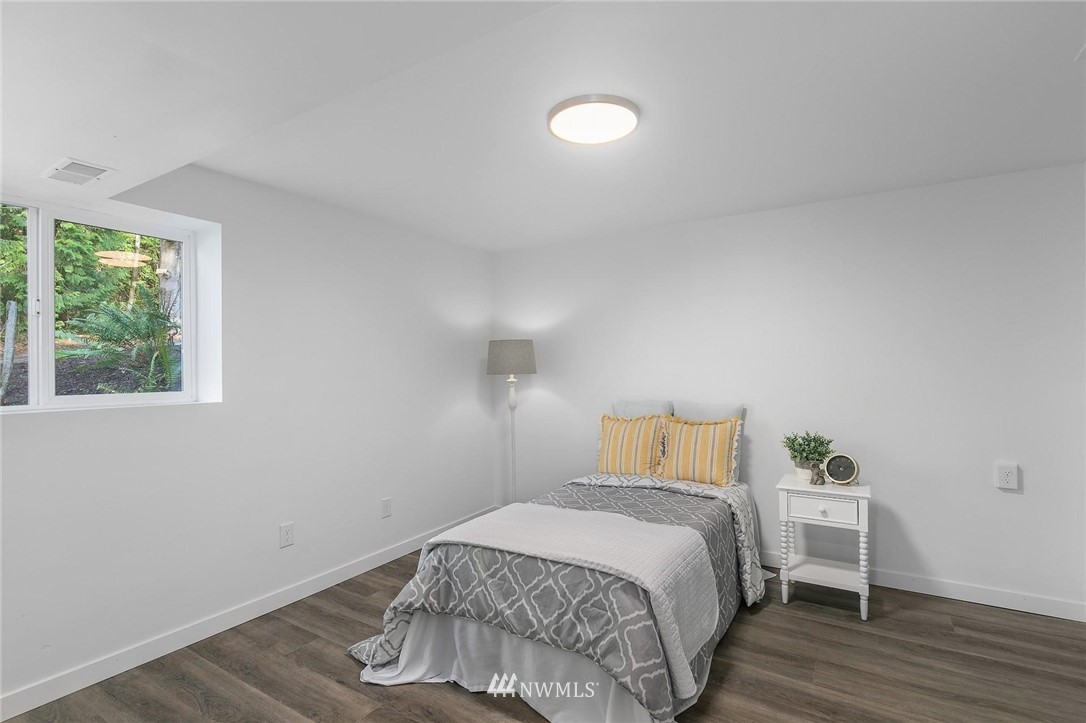 24207 39th Avenue Southeast Bothell, WA 98021 - Photo 23 of 39 a bedroom with a bed and wooden floor