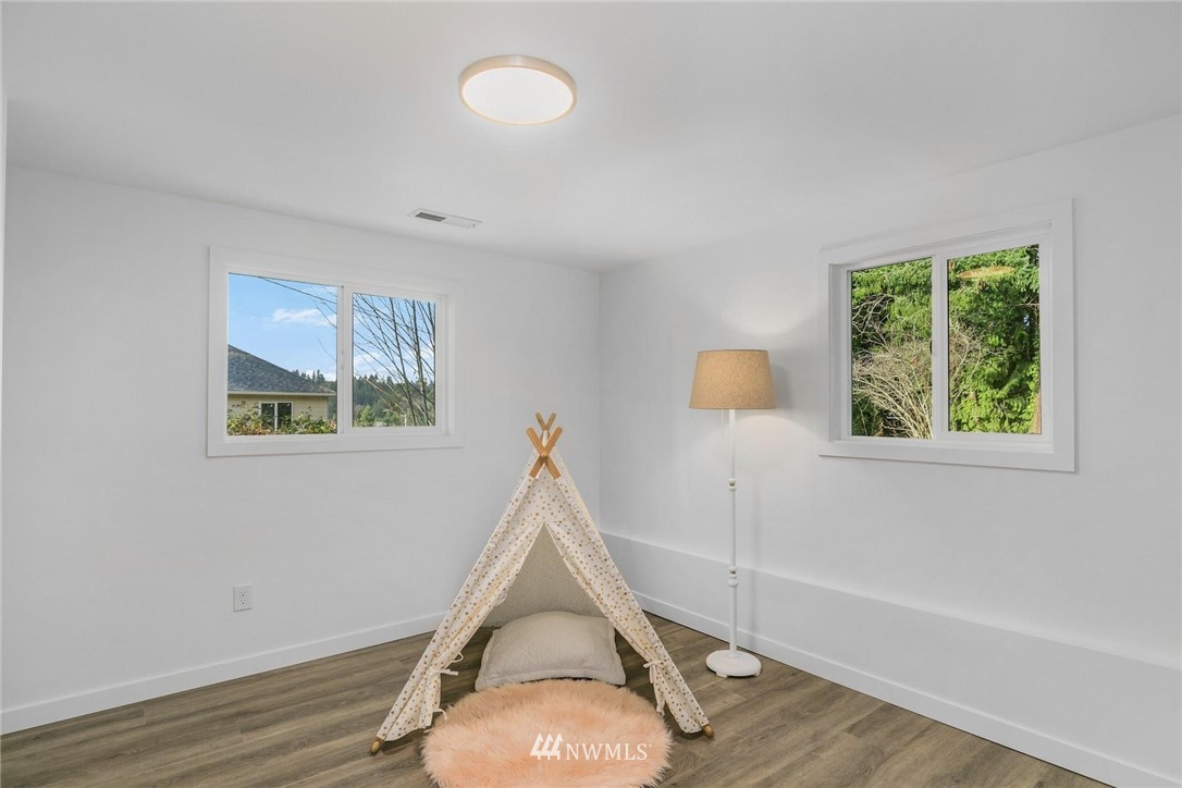 24207 39th Avenue Southeast Bothell, WA 98021 - Photo 27 of 39 a view of a room with wooden floor and fan