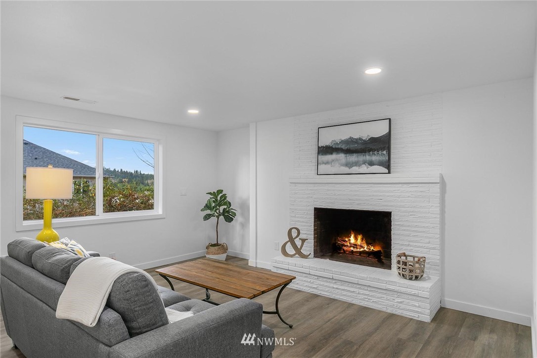 24207 39th Avenue Southeast Bothell, WA 98021 - Photo 28 of 39 a living room with furniture and a fireplace
