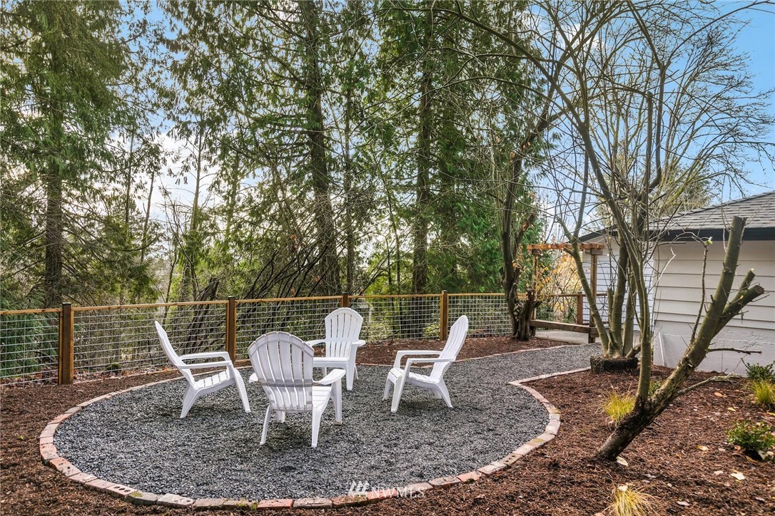24207 39th Avenue Southeast Bothell, WA 98021 - Photo 33 of 39 a view of a lake with a table and chairs