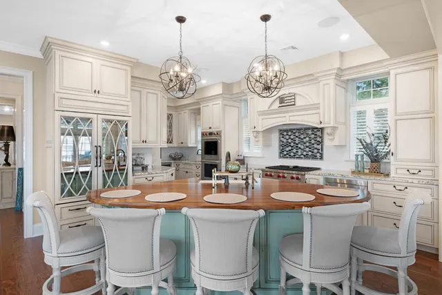 a dining room with furniture a chandelier and window