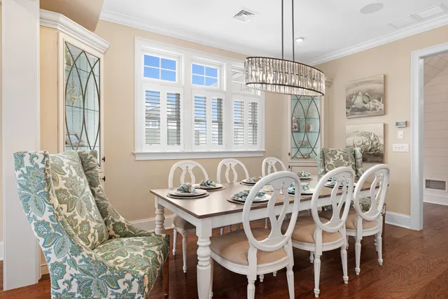 a view of a dining room with furniture and chandelier