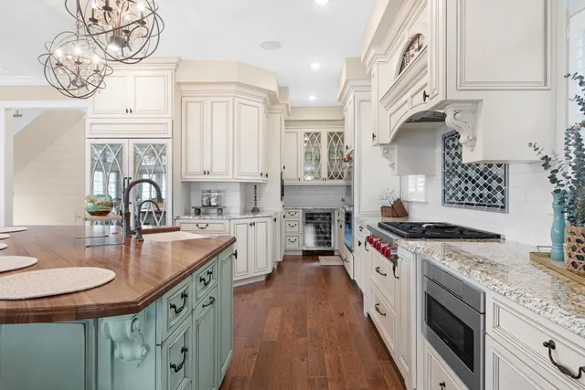 a kitchen with stainless steel appliances granite countertop a sink stove and cabinets
