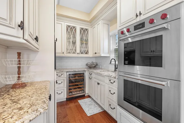 a kitchen with stainless steel appliances granite countertop a stove and cabinets