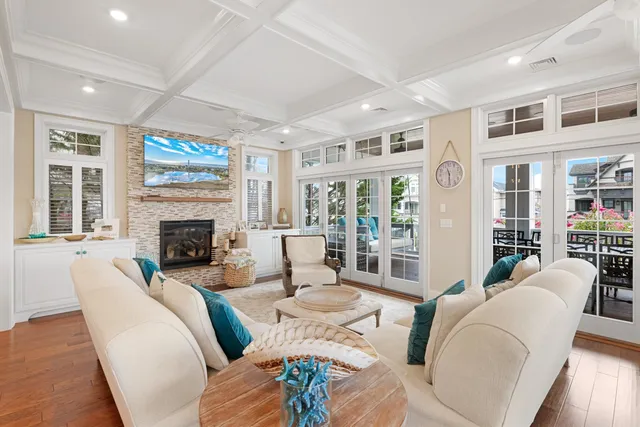 a living room with furniture fireplace and a large window