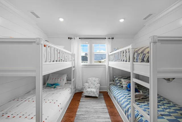 a bedroom with furniture and a wooden floor