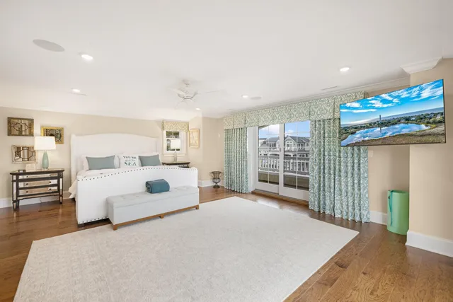 a bedroom with a large bed and a large window