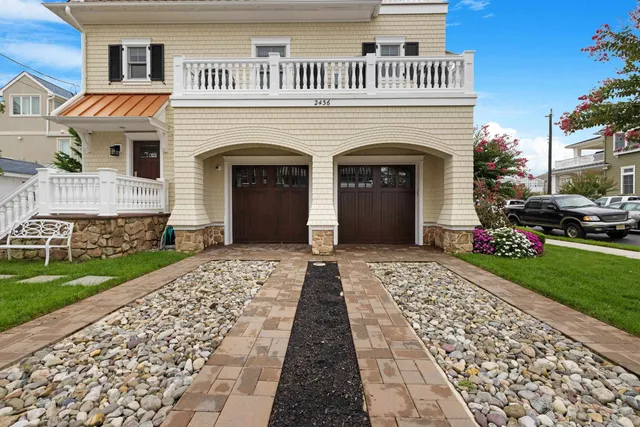 a front view of a house with a garden