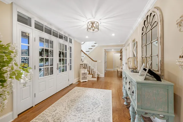 a view of a livingroom with furniture stairs and a chandelier