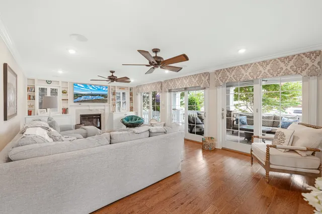 a living room with furniture floor to ceiling window and a fireplace