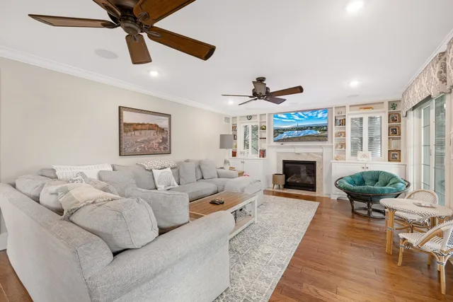 a living room with furniture a fireplace and a flat screen tv