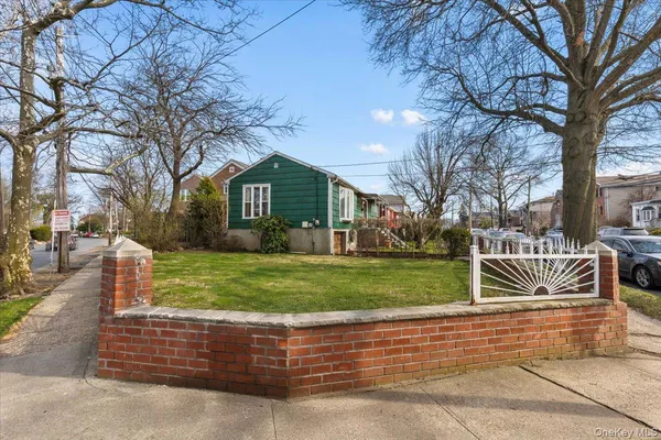 a front view of a house with a yard table and chairs