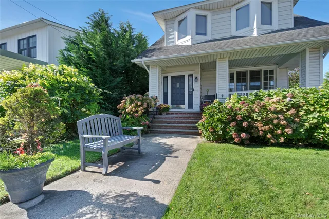 a view of a chair and table in backyard of the house
