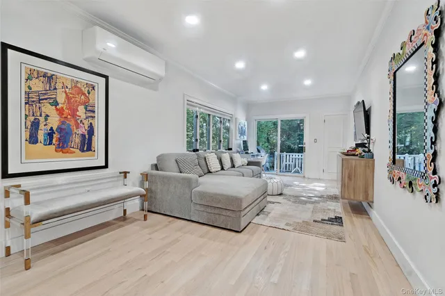 a living room with furniture large window and flat screen tv