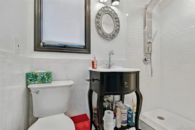 a bathroom with a toilet a sink and a mirror