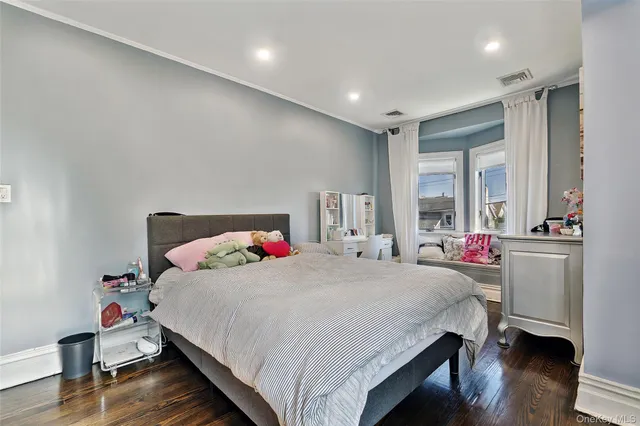 a bedroom with a bed and a desk