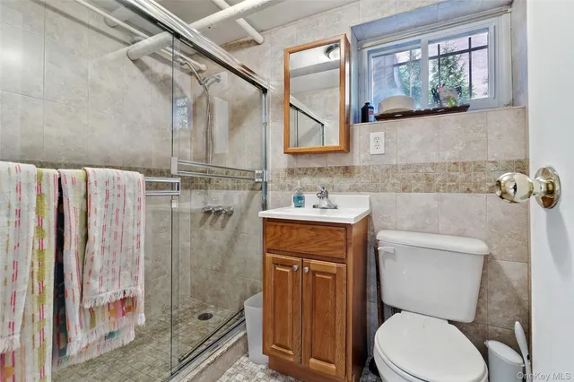 a bathroom with a toilet sink and shower