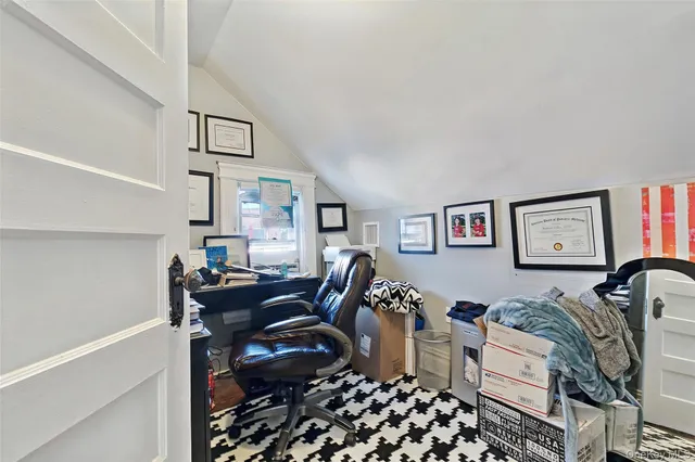 a living room with furniture a piano and a window