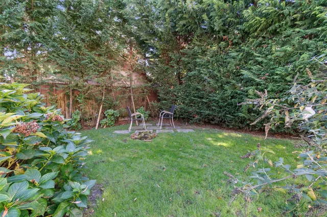 a view of backyard with a table and chairs