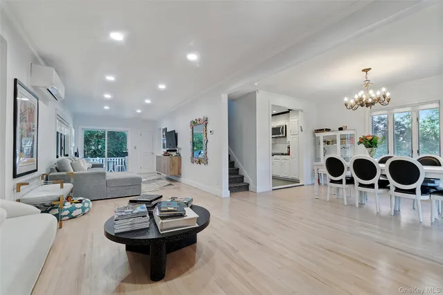 a living room with furniture a dining table and chairs