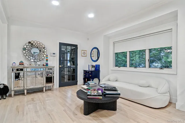 a living room with fireplace furniture and a large window