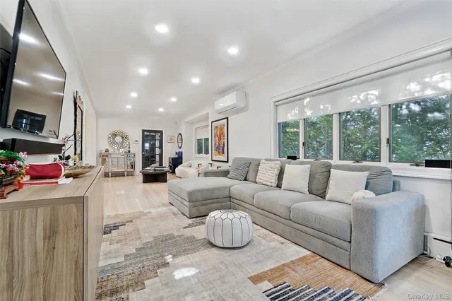 a living room with furniture fireplace and a large window