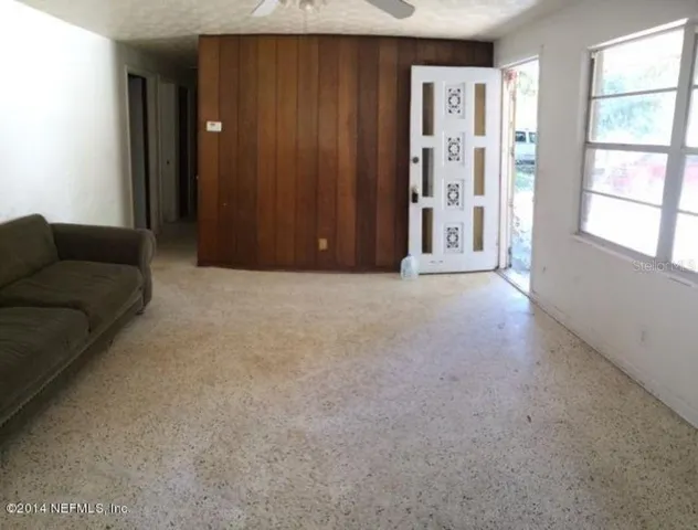 an empty room with windows and closet