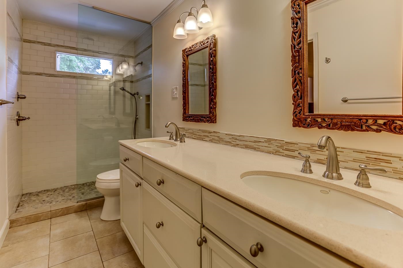 801 Moss Road Memphis, TN 38117 - Photo 14 of 28 Remodeled with tile floor, 6' solid surface double vanity with 4 drawers, 5' shower with Subway tile walls and mosaic pebble floor. Photo taken from walk-in closet.
