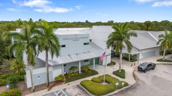 a view of a house with pool and chairs