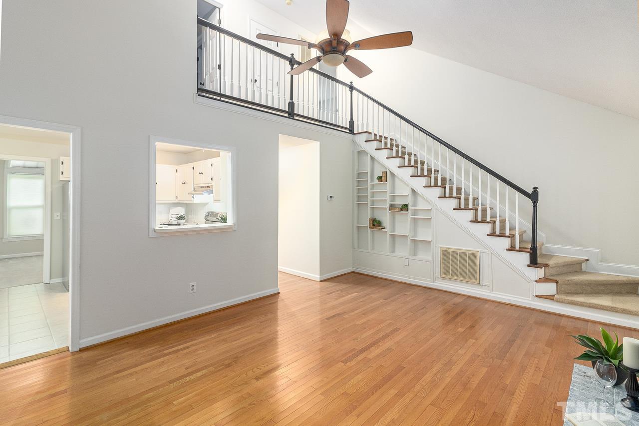 4704 Dillingham Court Raleigh, NC 27604 - Photo 2 of 10 Walk into the spacious living room that features built ins on the staircase, beautiful wood floors and a fireplace.