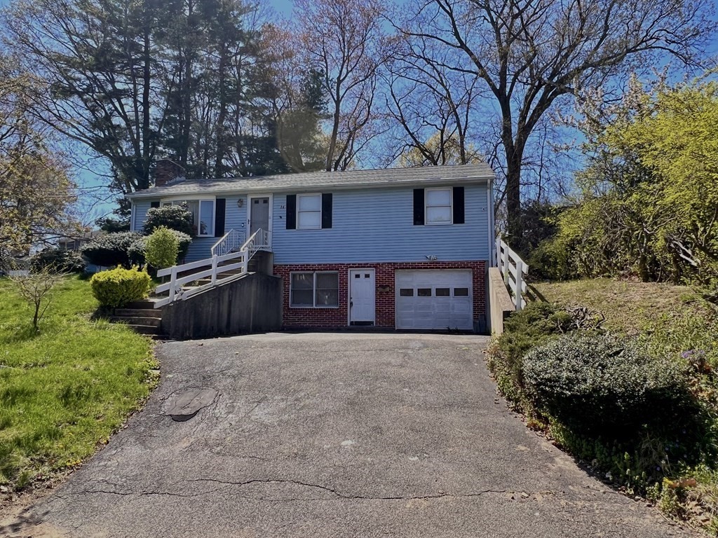 24 Emerson Street Springfield, MA 01118 - Photo 1 of 19 a front view of a house with a yard and garage