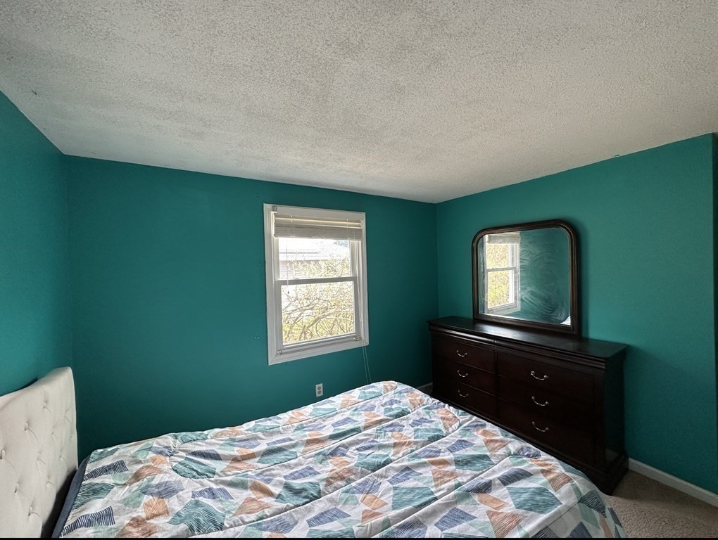 24 Emerson Street Springfield, MA 01118 - Photo 13 of 19 a bedroom with a bed and a window