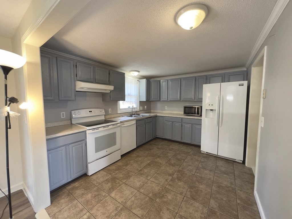 24 Emerson Street Springfield, MA 01118 - Photo 2 of 19 a kitchen with a sink stainless steel appliances and cabinets