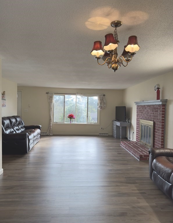 24 Emerson Street Springfield, MA 01118 - Photo 5 of 19 a view of livingroom with furniture fireplace and wooden floor
