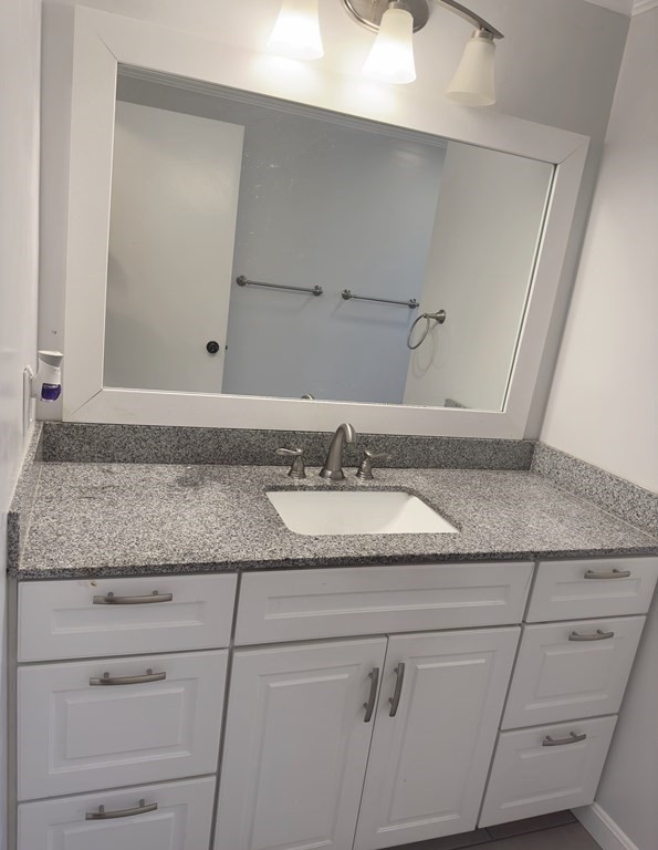 24 Emerson Street Springfield, MA 01118 - Photo 6 of 19 a bathroom with a granite countertop sink and a mirror