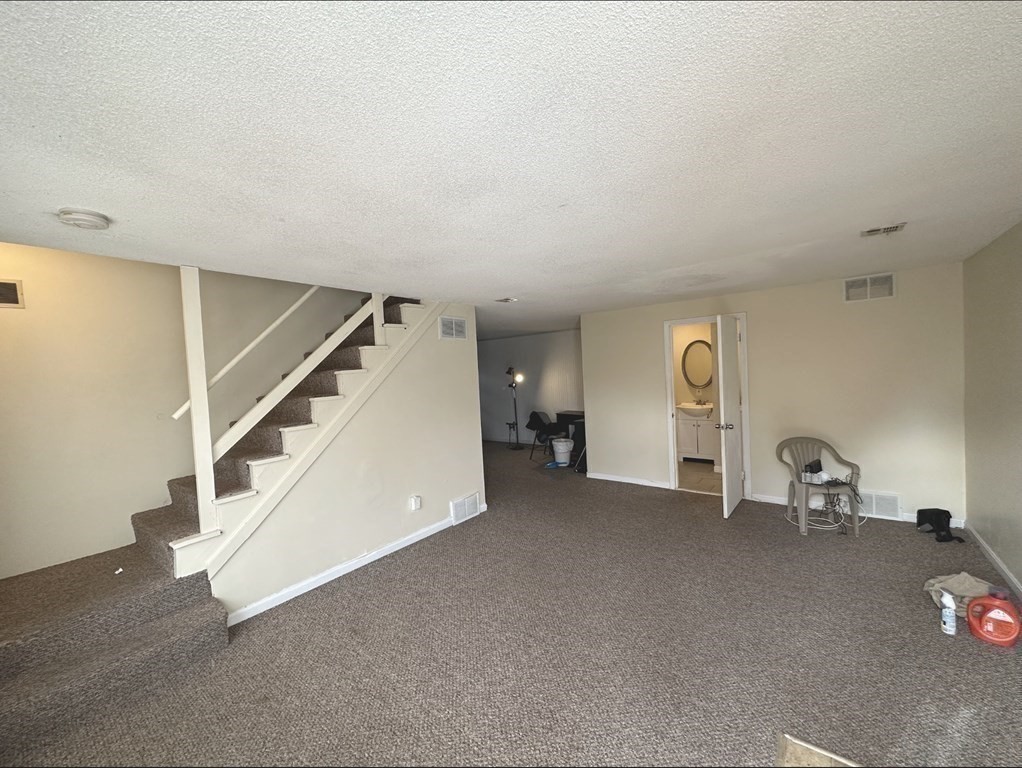 24 Emerson Street Springfield, MA 01118 - Photo 8 of 19 a view of a livingroom with a staircase