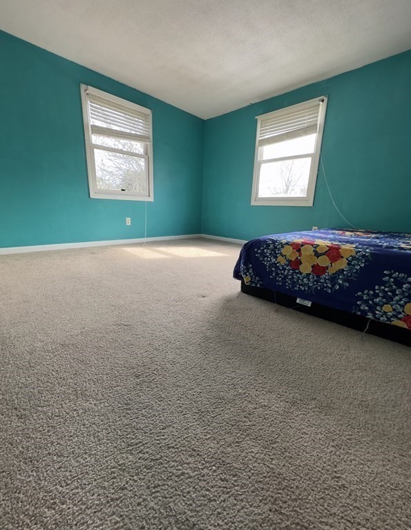 24 Emerson Street Springfield, MA 01118 - Photo 10 of 19 a bedroom with a bed and a window