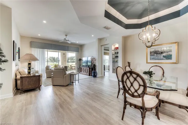 a view of a dining room with furniture wooden floor and chandelier