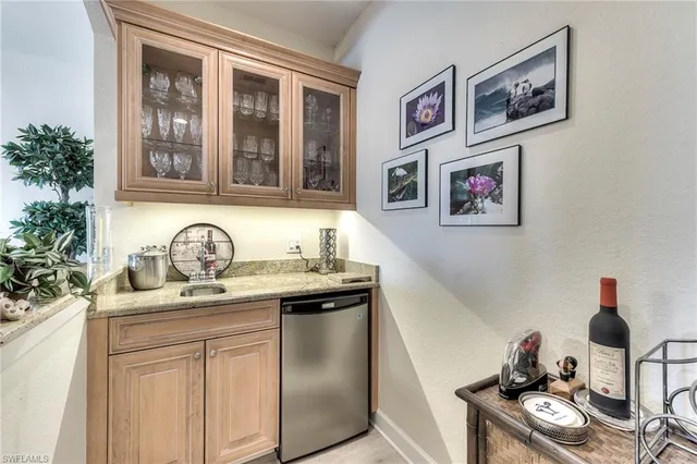 a kitchen with stainless steel appliances granite countertop a sink and cabinets