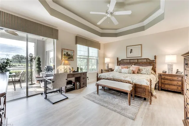 a bedroom with furniture and large windows