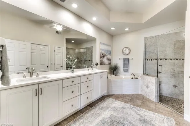 a bathroom with a double vanity sink mirror and shower