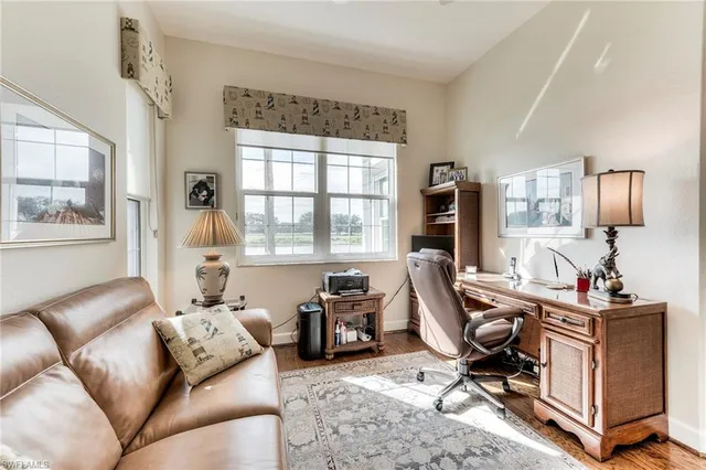 a view of a livingroom with workspace and a window