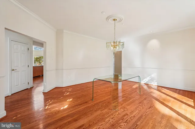 a view of room with window and wooden floor
