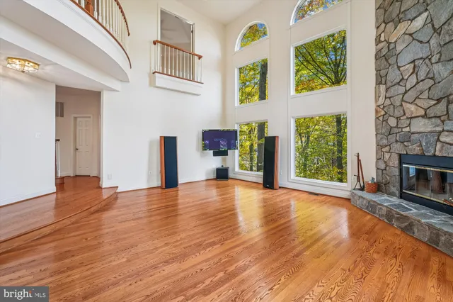 a bathroom with a bathtub shower sink vanity mirror and toilet
