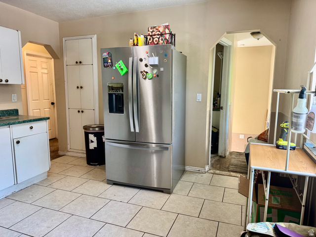 470 East Center Street Logan, UT 84321 - Photo 3 of 16 Kitchen area featuring white cabinetry, light-toned tile flooring, and a built-in pantry with multiple storage compartments