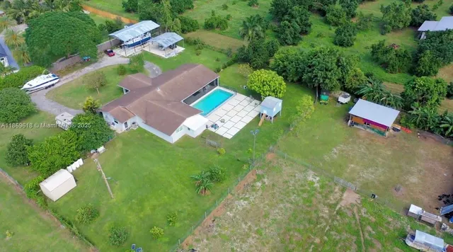an aerial view of residential house with outdoor space and swimming pool