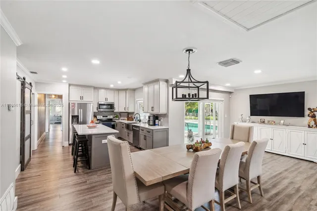 a view of a dining room with furniture window and wooden floor