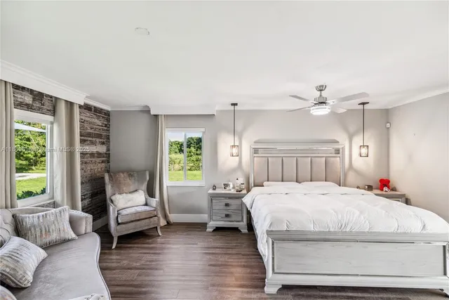 a bedroom with a bed couch and a window