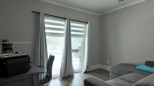 a view of a livingroom with furniture and a window