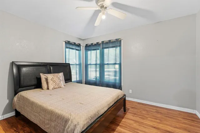 a bedroom with a large bed and a window